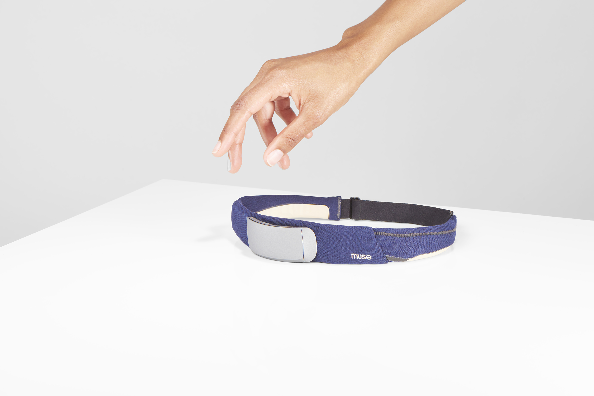 Hand reaching for a headband device